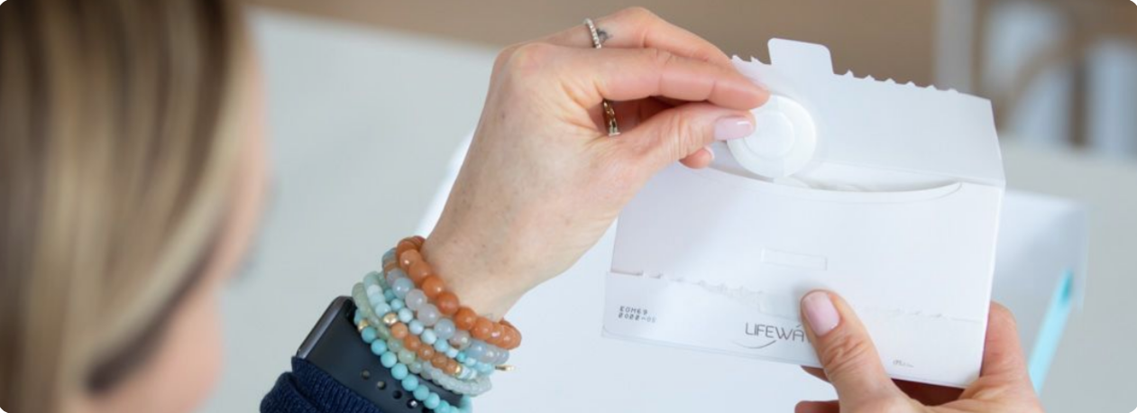 a woman pulling a patch out of a sleeve 