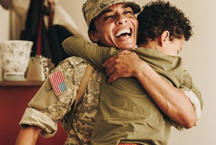a female soldier hugging her son 