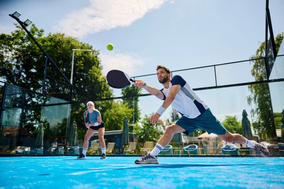 Floodlit padel court during a match