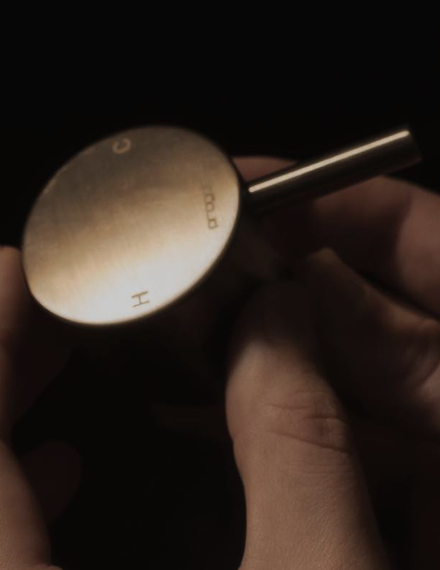 A Buddy mixer handle held in the hand