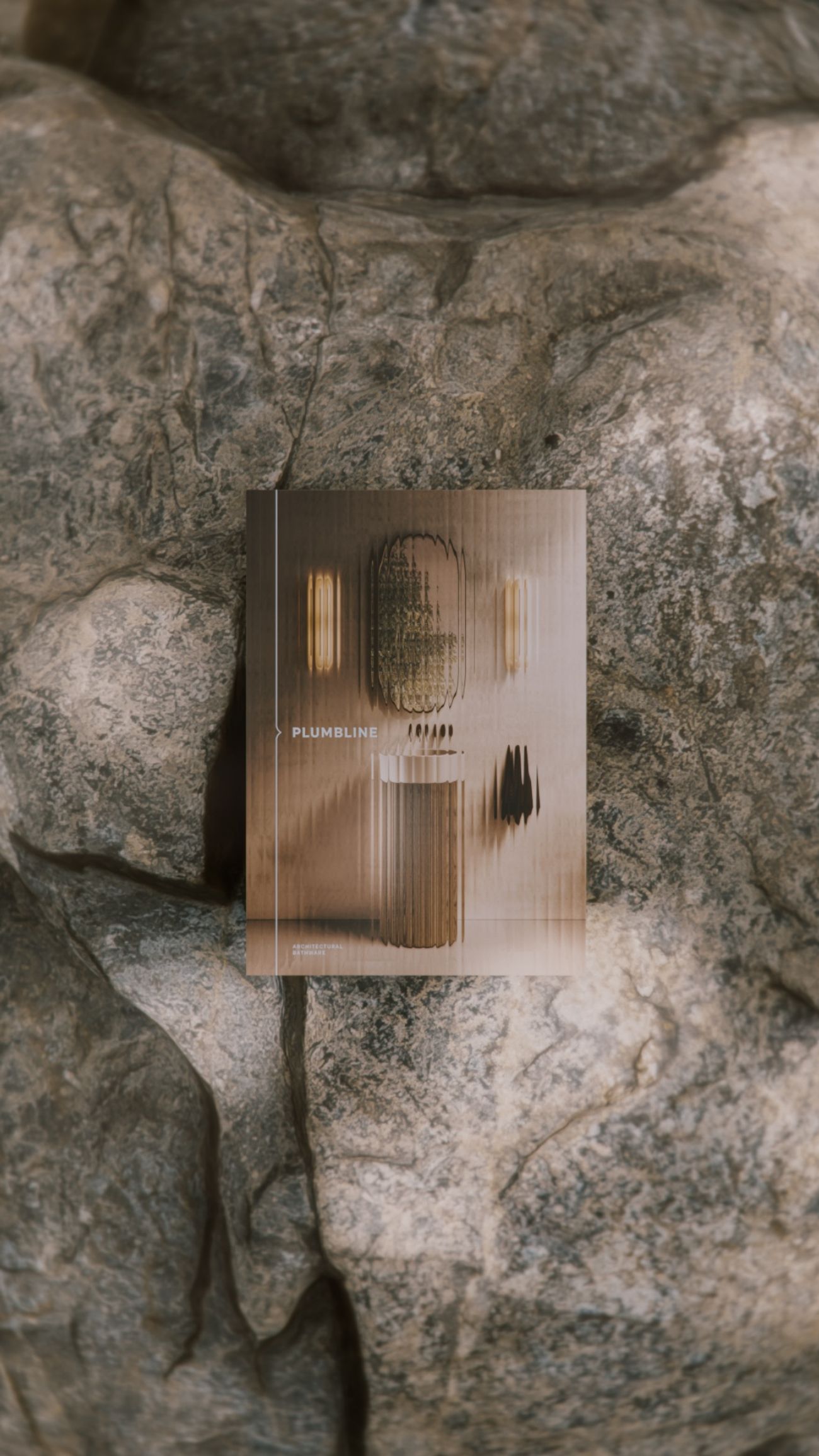 The Plumbline catalogue lying on weathered stone