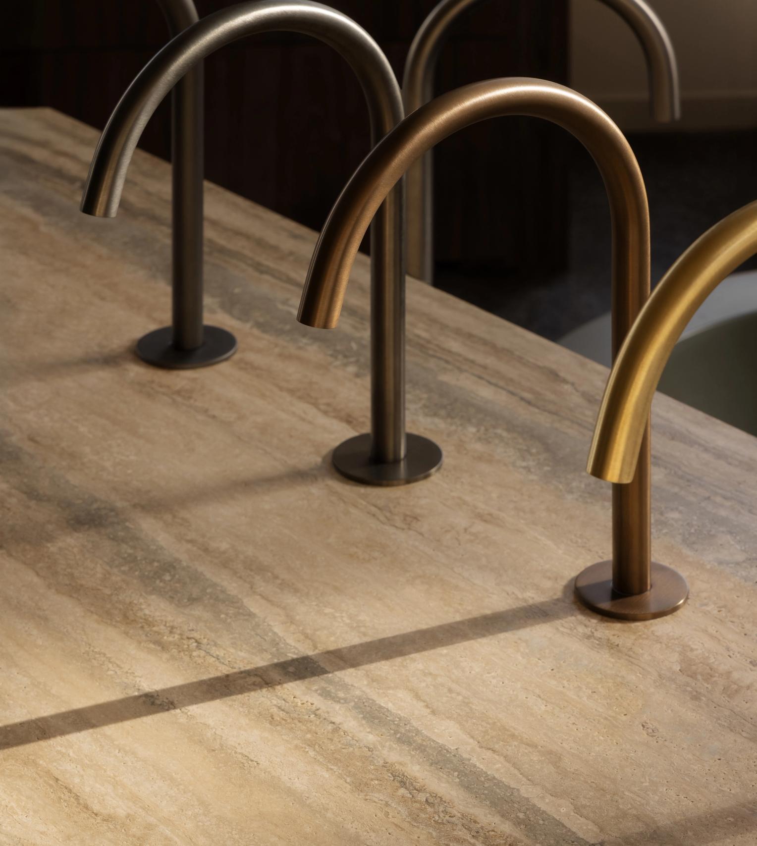 Basin mixer spouts shown in multiple finishes