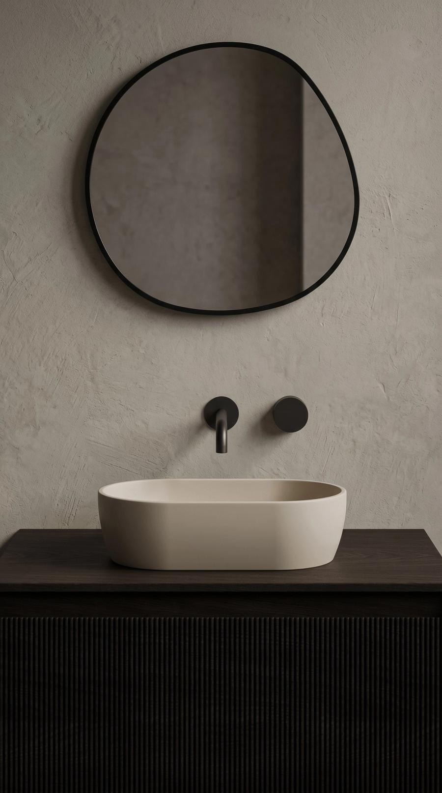 Oasis oval basin on a fluted dark vanity below a round mirror