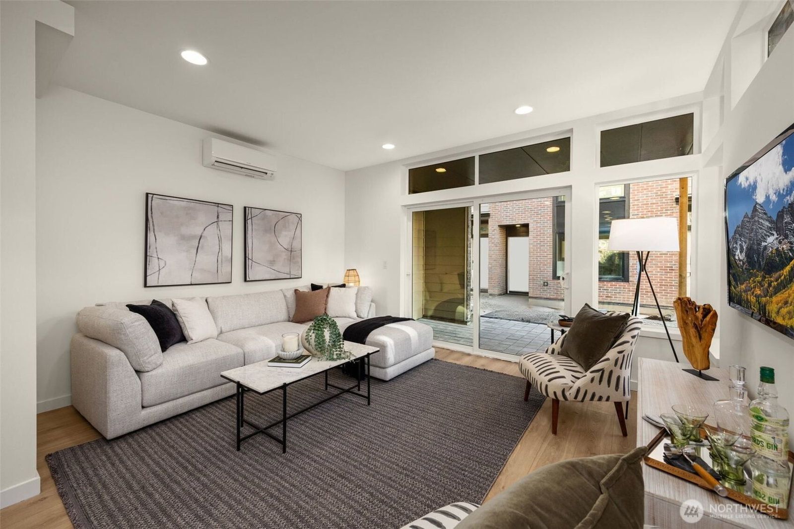Second-floor living room with a wall of windows to the courtyard
