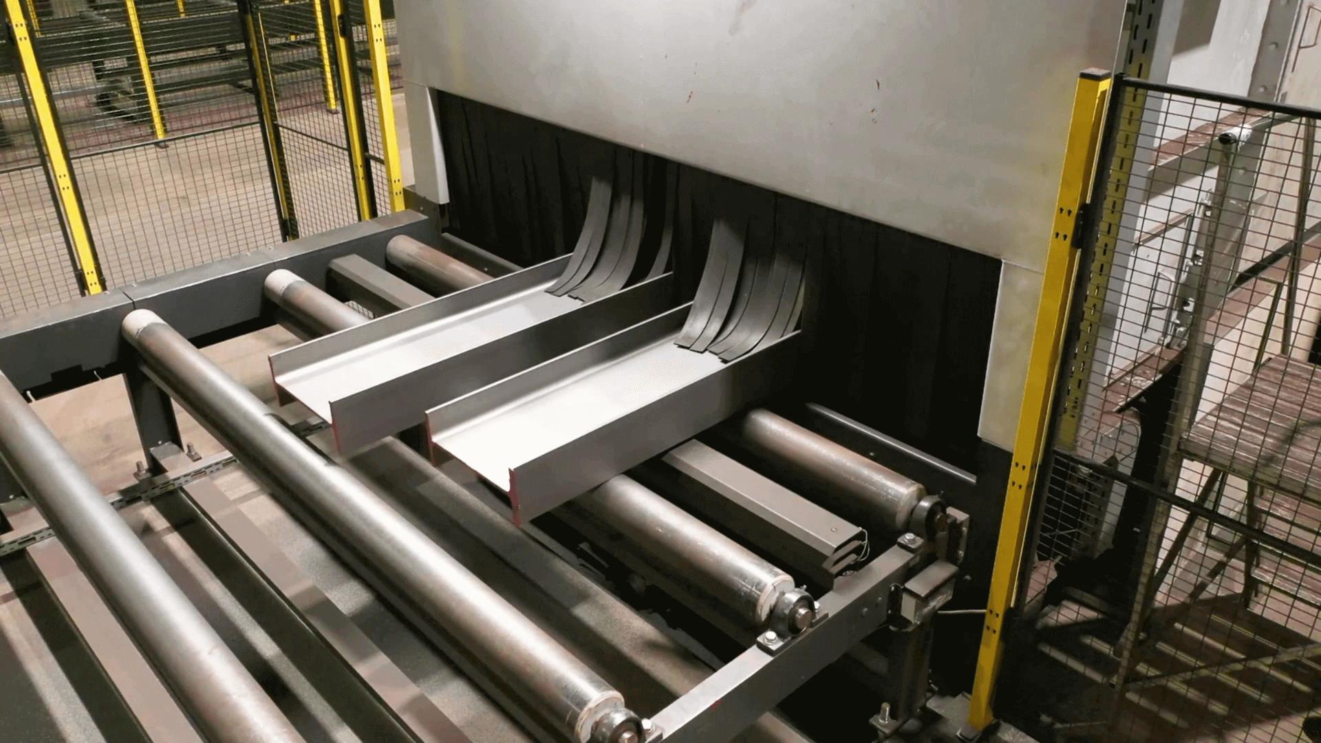 Steel profiles moving along a roller conveyor in BE Group’s factory