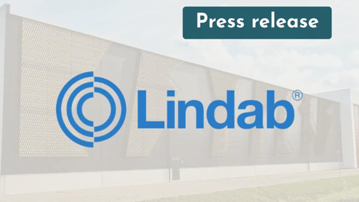 Lindab logo over a photo of an industrial building with a perforated metal façade