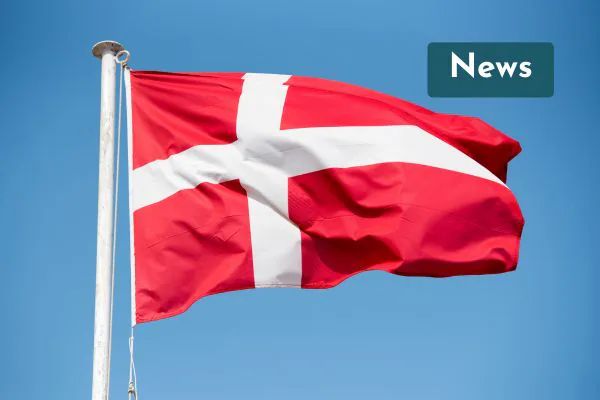 The Danish flag flying against a blue sky