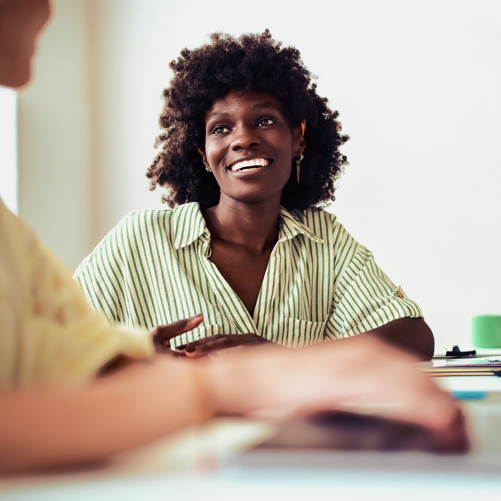 Woman laughs during a bright team meeting
