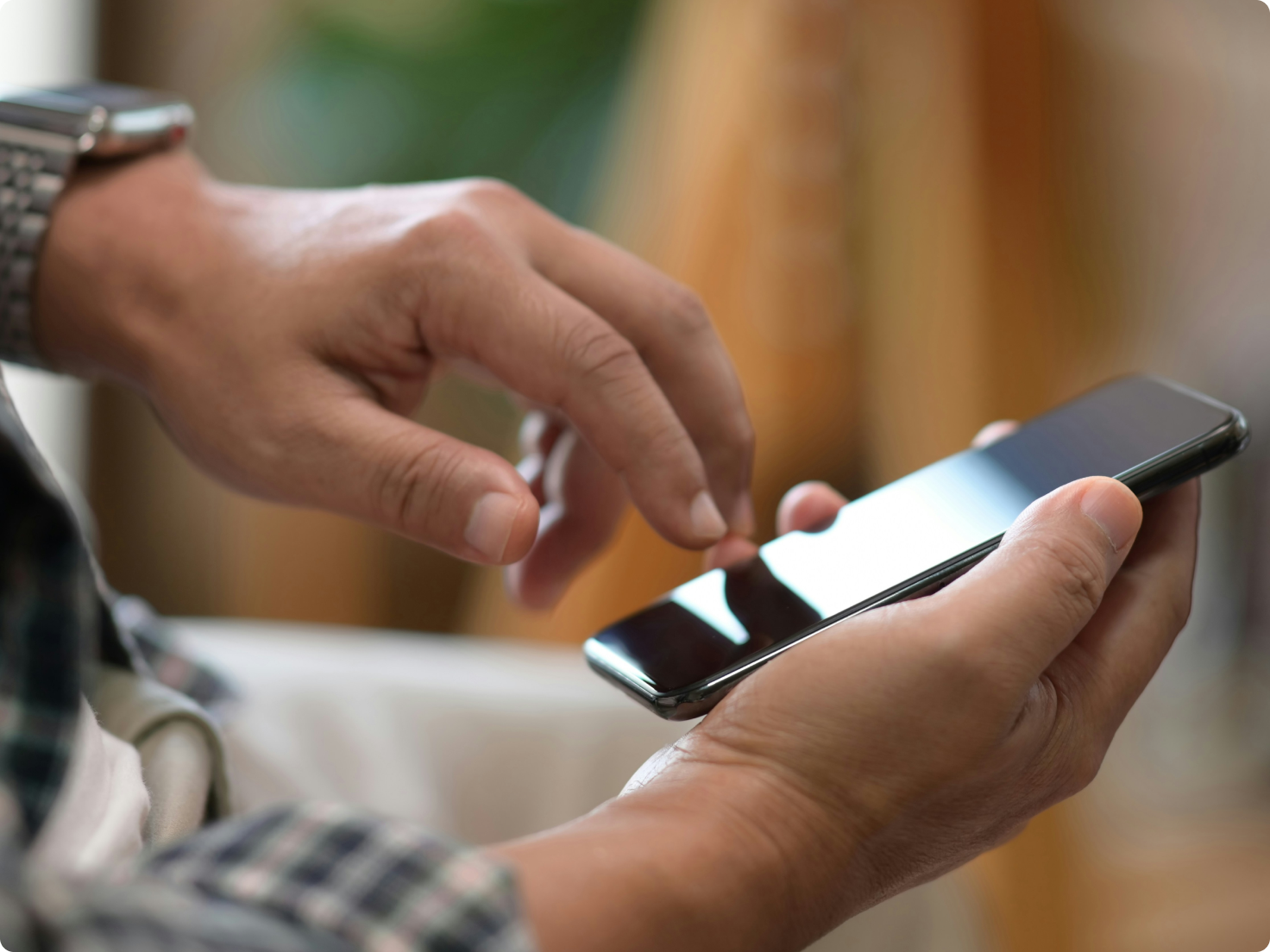 Lawyers checking a smartphone, with a smartwatch on their wrist