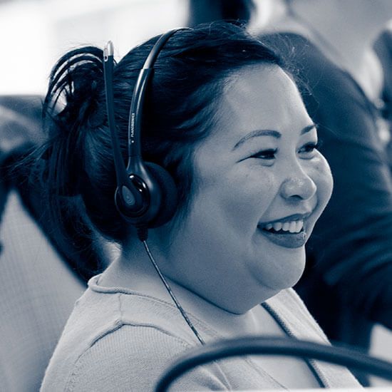 Smiling woman wearing a headset.