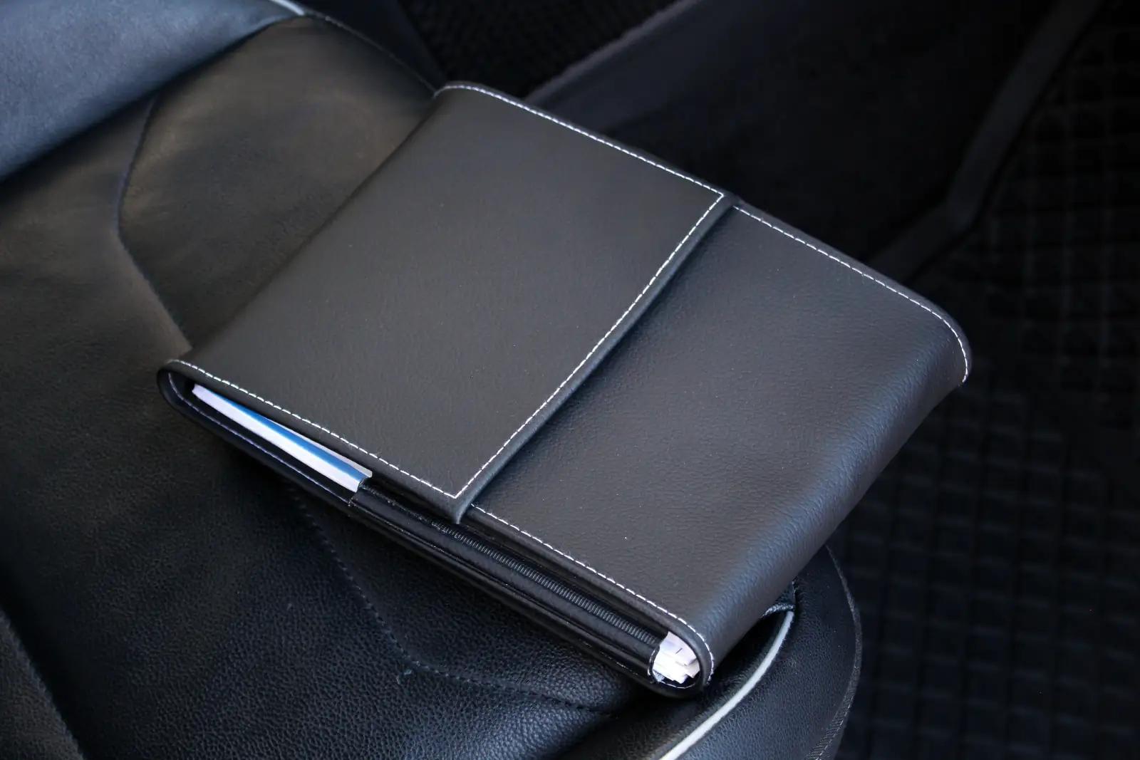 Check car service history - professional mechanic reviewing vehicle service records