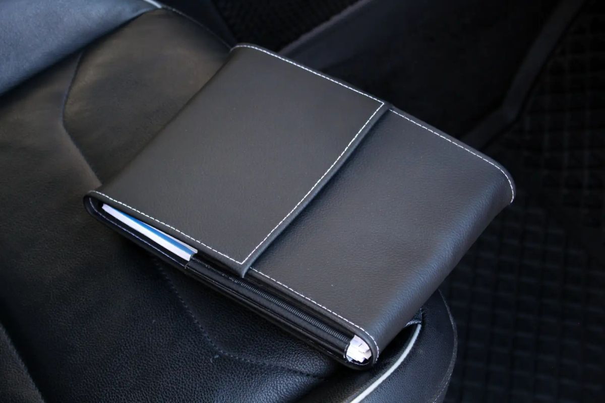 Check car service history - professional mechanic reviewing vehicle service records