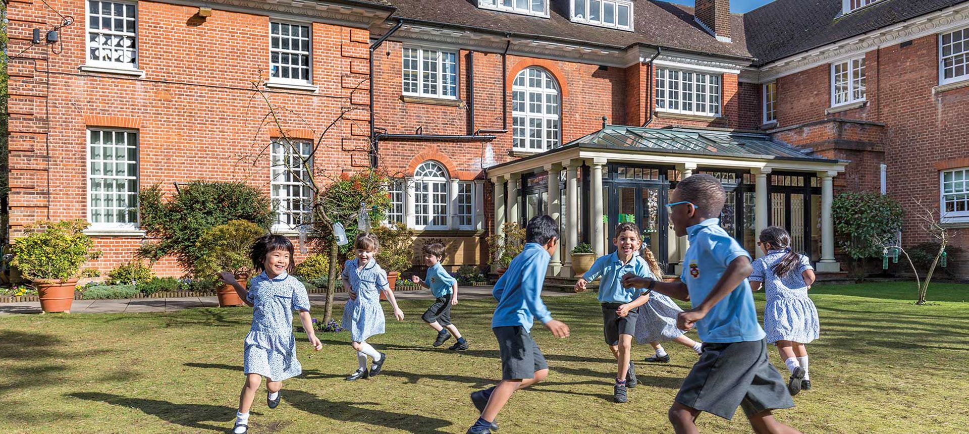 Children playing outside Grimsdell school 