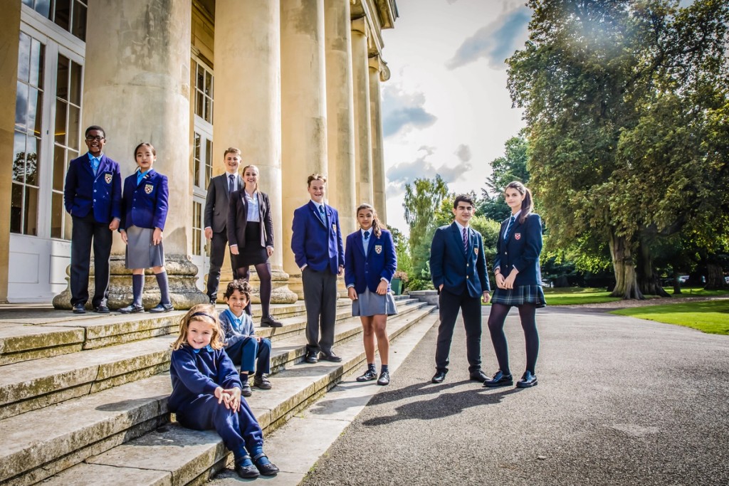 Image of young and older students outside Mill Hill School