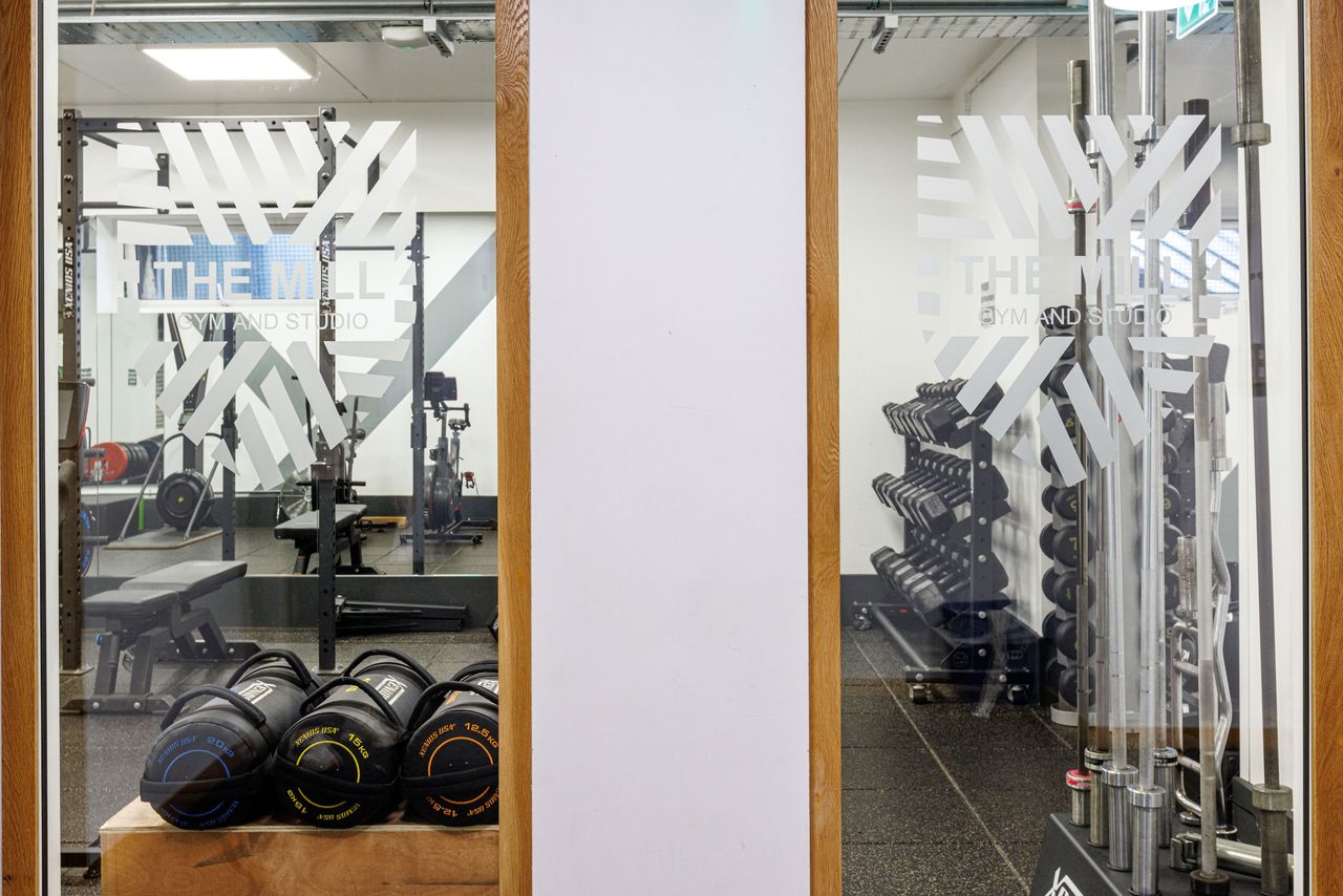 Image of a view of inside The Mill Gym & Studio through two glass windows. 