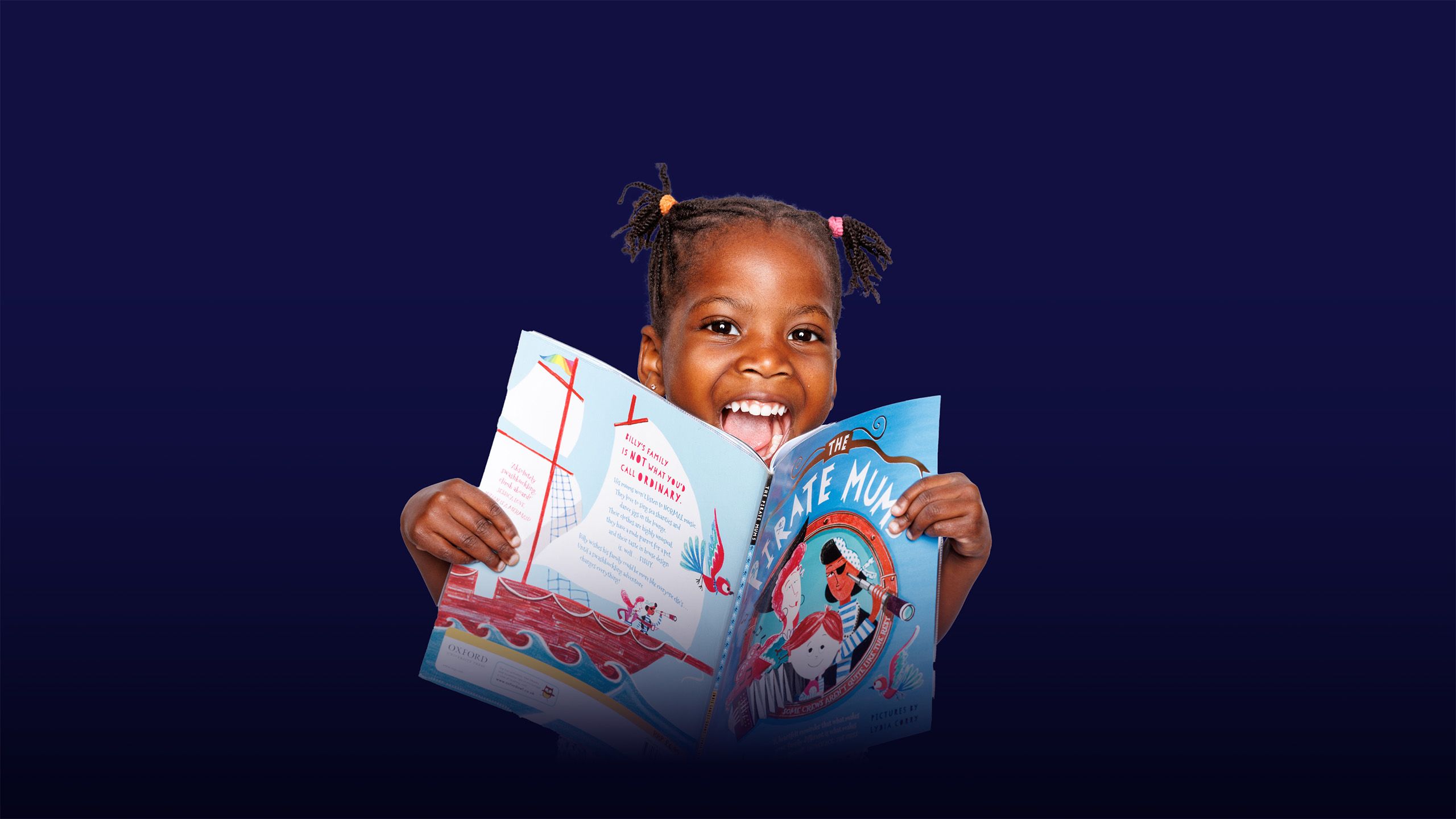 A little girl against a dark background, looking straight ahead with an open mouth smile, holding an opened book, with an overlay of the text "inspiring minds" 