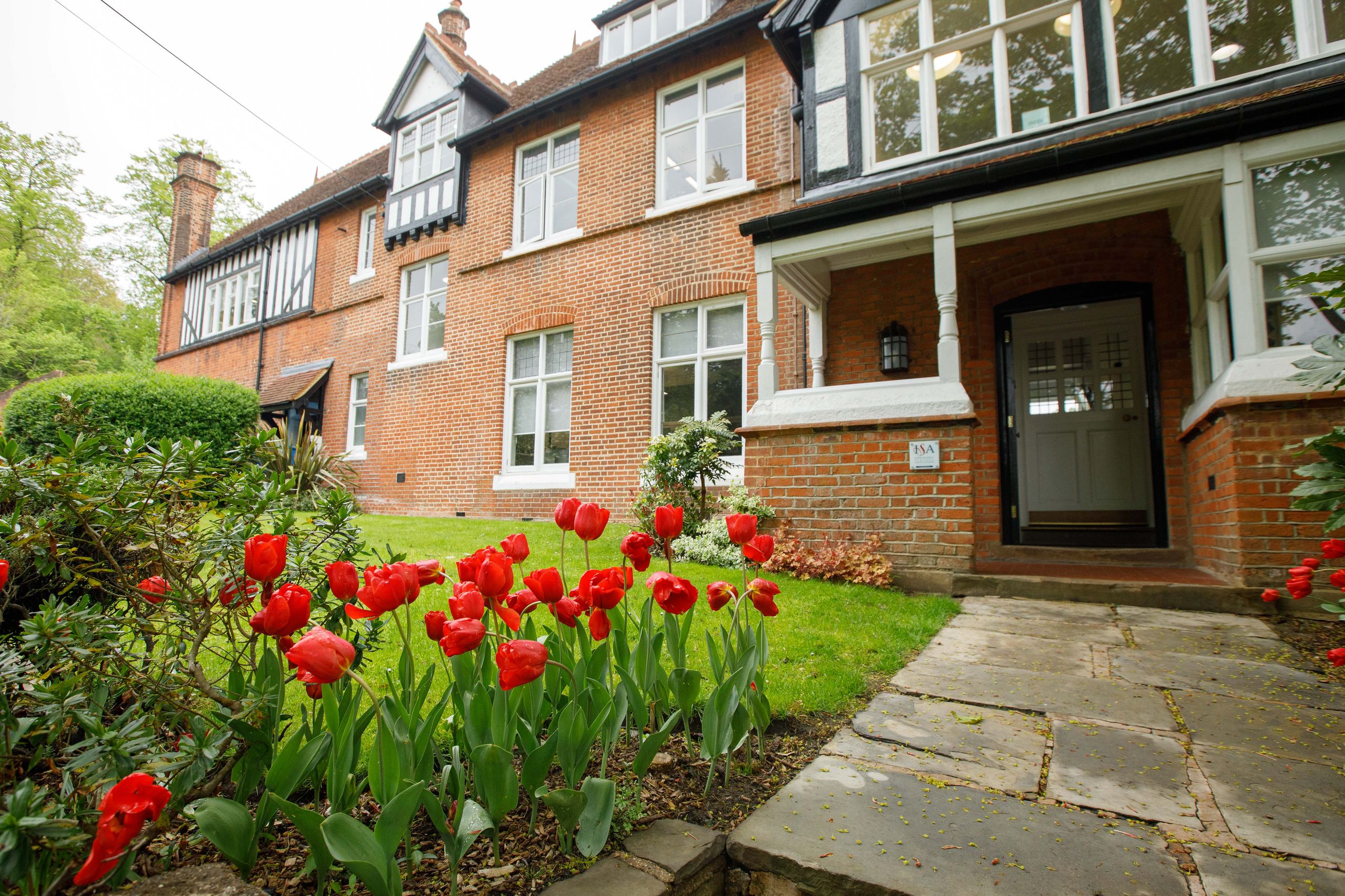 A brick building and red tulips 