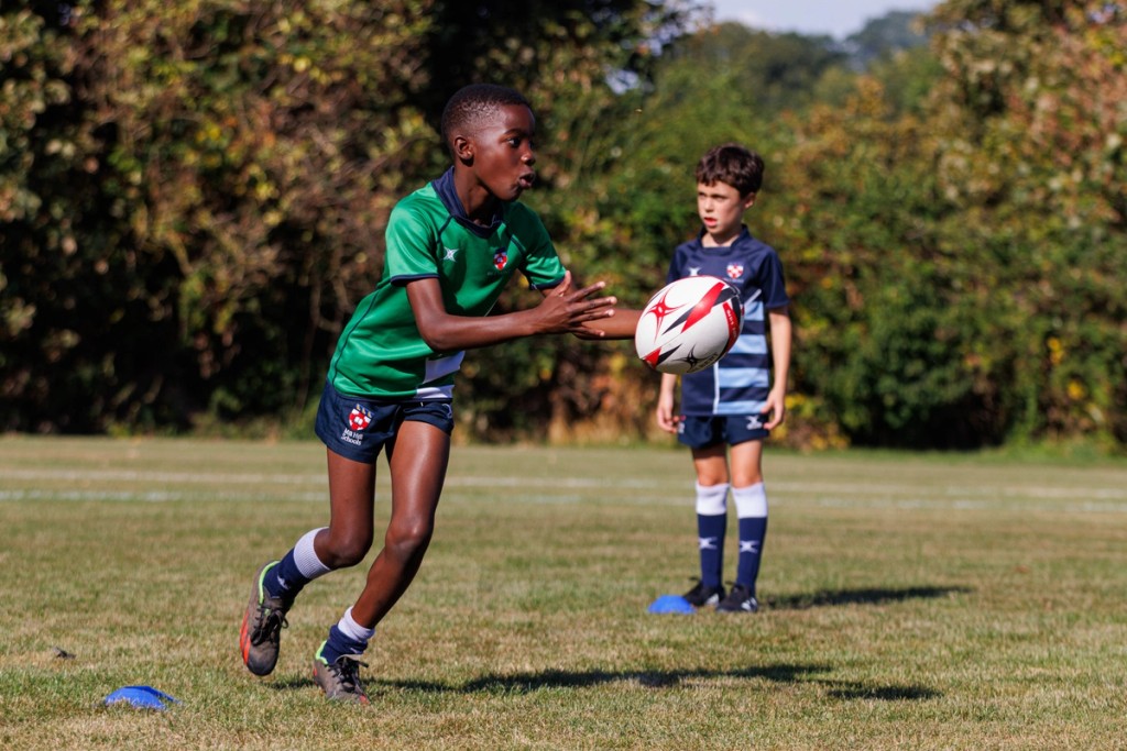 Two young boys in the middle of rugby training