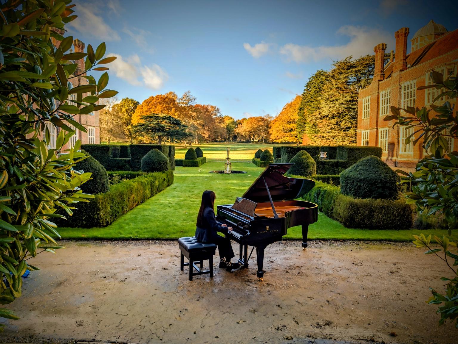 Image taken at Cobham Hall of a girl seated at a piano