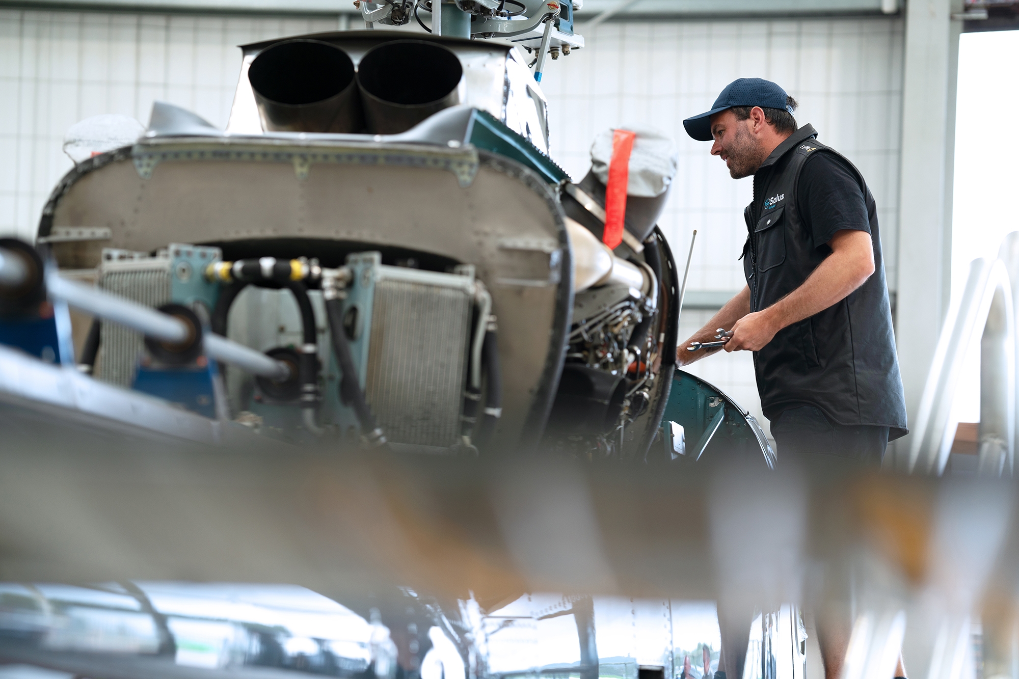Helicopter engineer working on aircraft in hangar