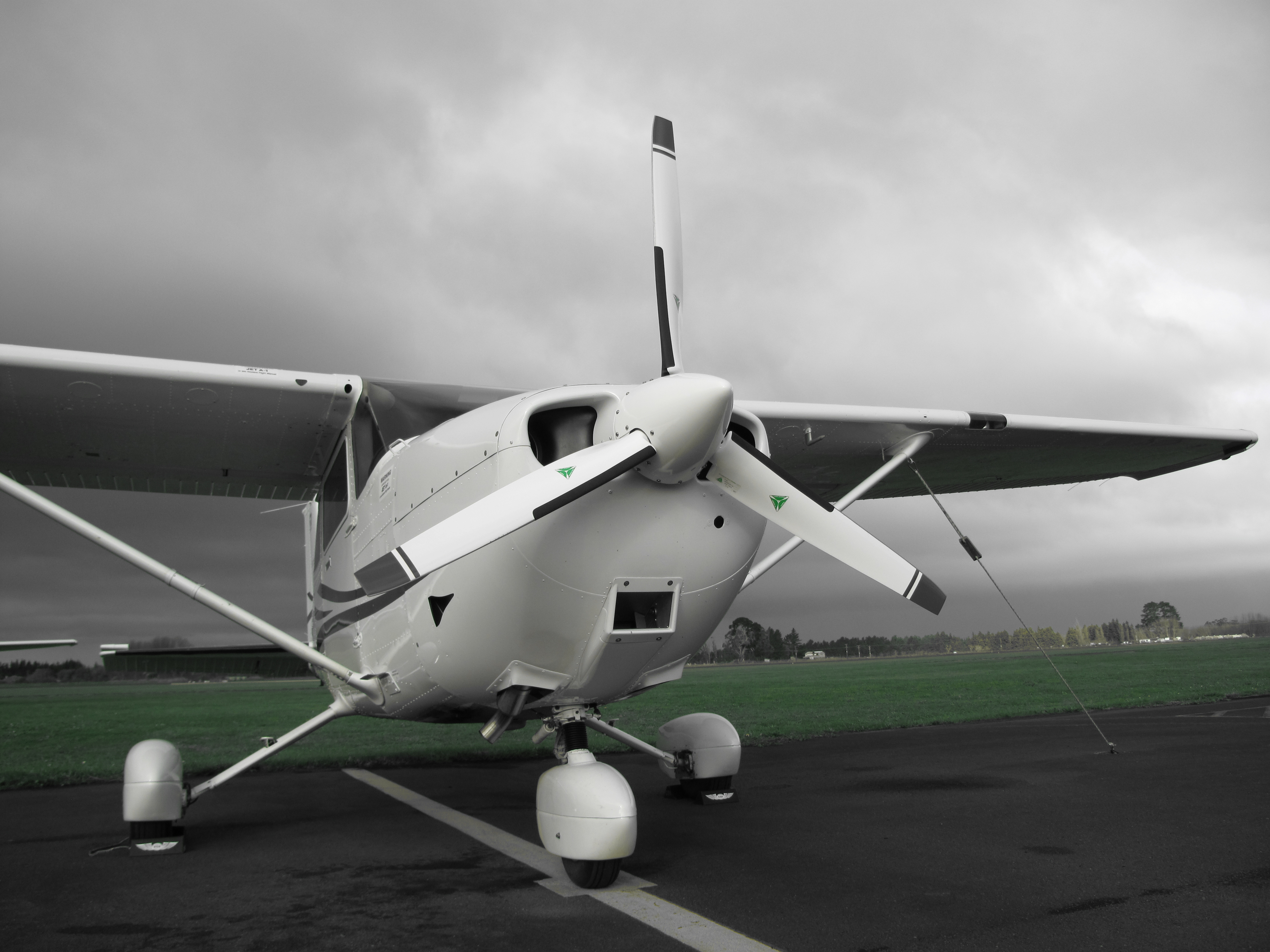 Fixed wing aircraft on airstrip on cloudy day