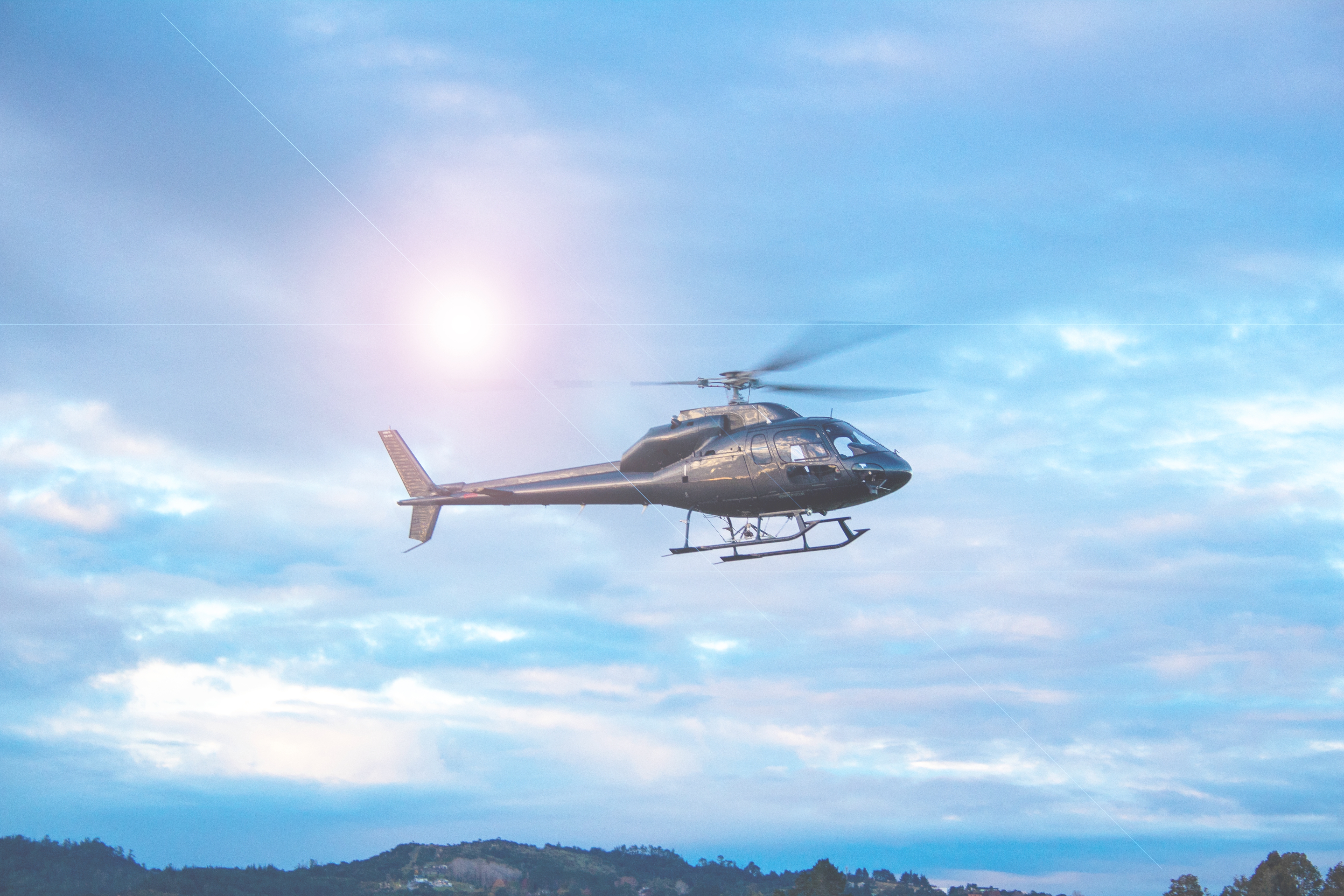 Helicopter flying in blue sky