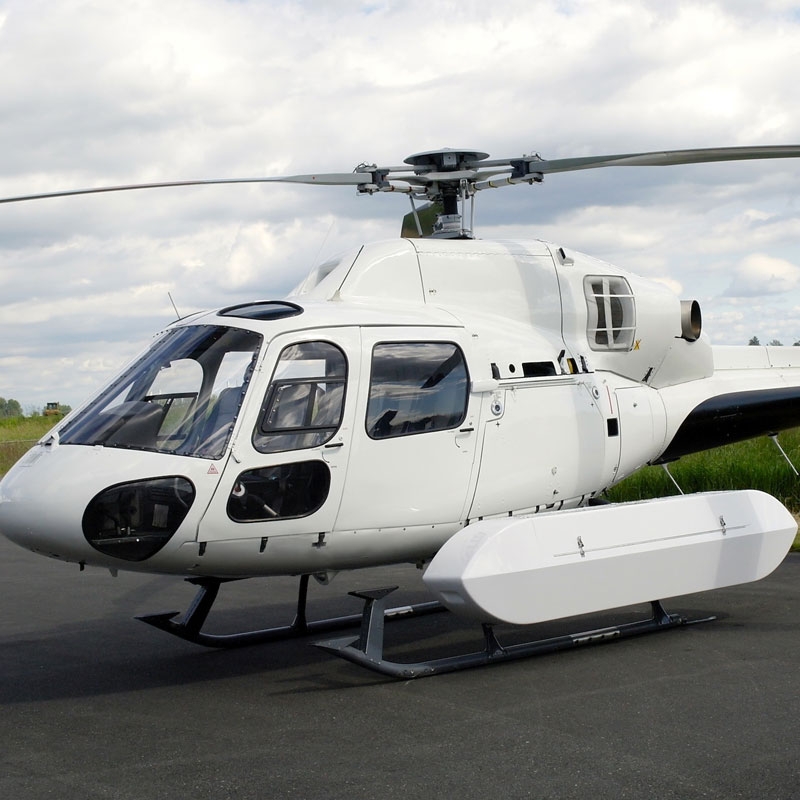 White cargo pod fitted to white helicopter