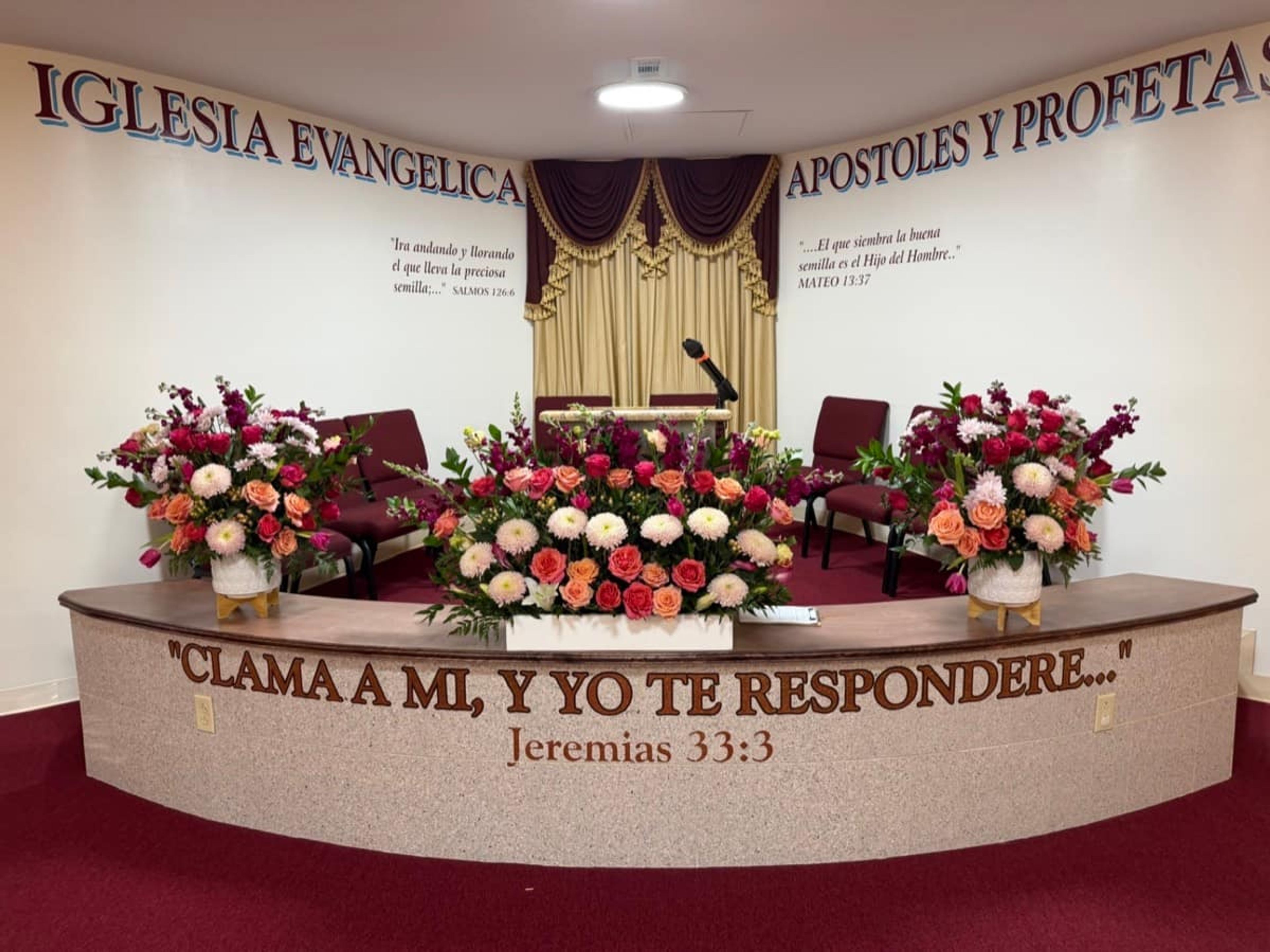 Church altar decorated with abundant white floral arrangements