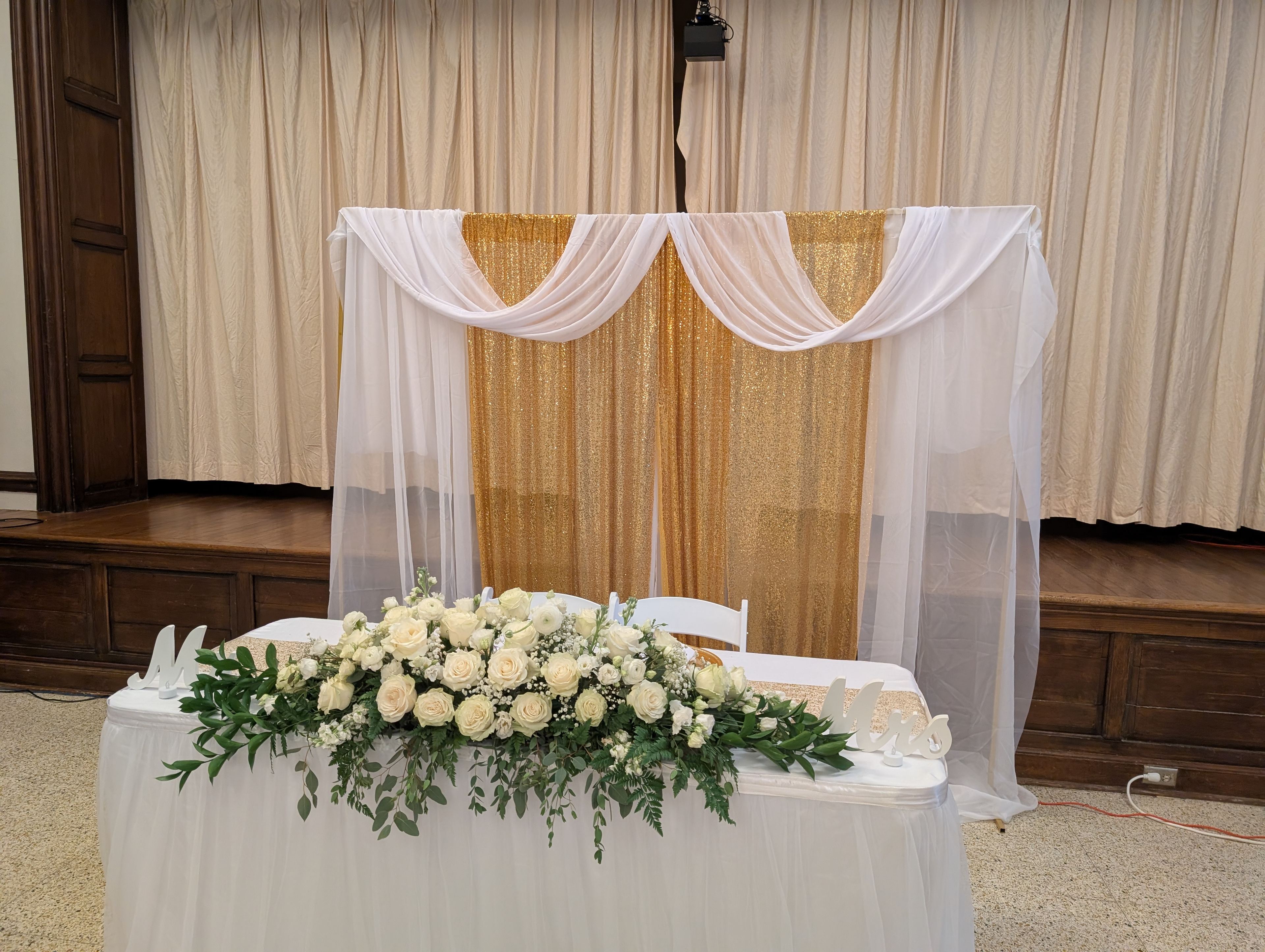Blush, ivory, and green wedding centerpiece on an elegant reception table