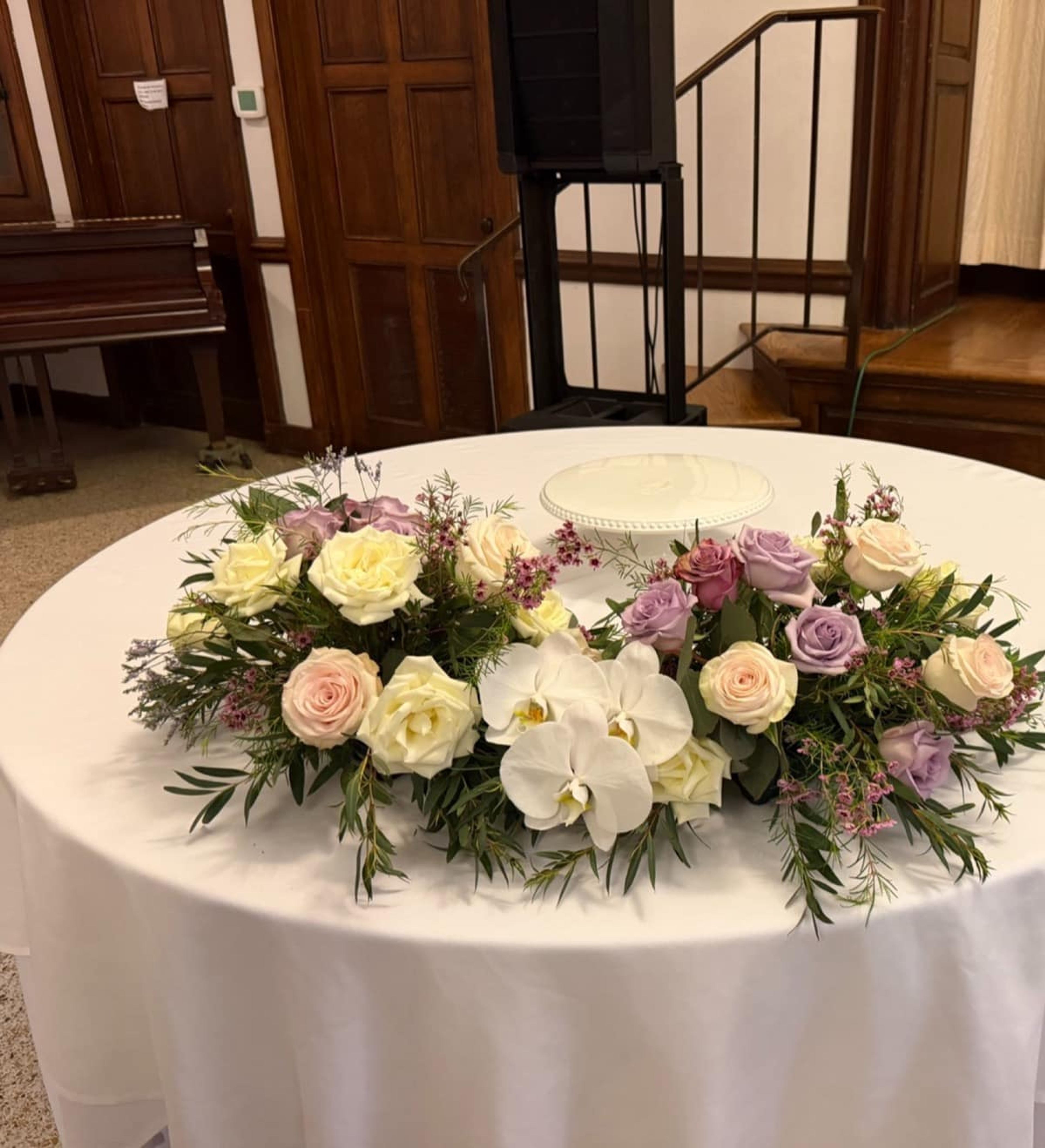 Fresh flowers arranged around an elegant wedding cake