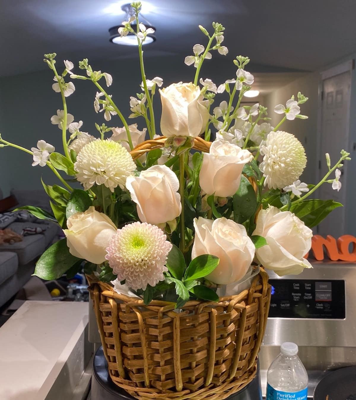 Seasonal floral basket filled with soft pink and white blooms