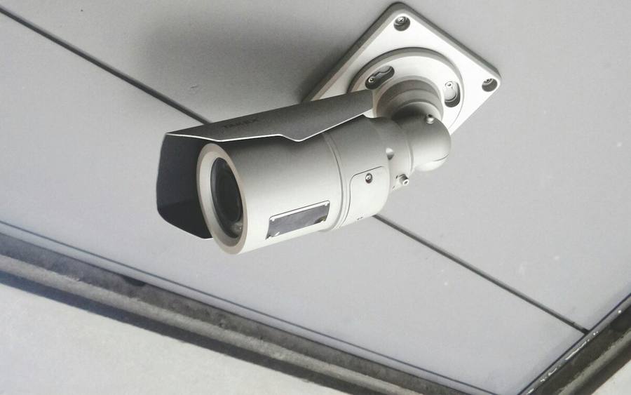 A ceiling-mounted camera in an office interior