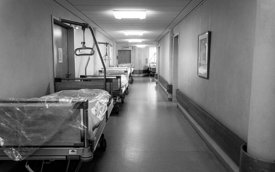 A hospital corridor lined with beds