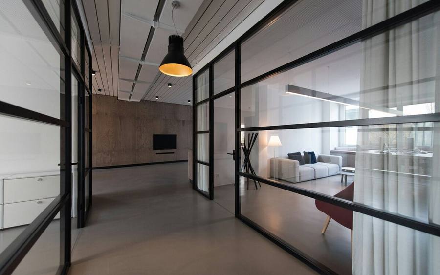An empty office interior behind glass partitions