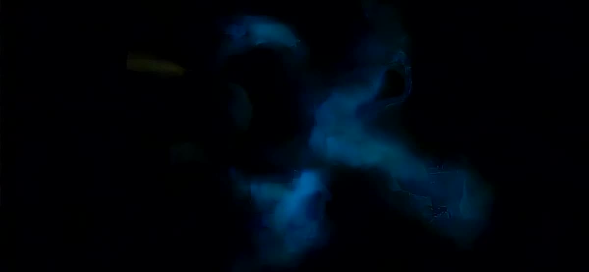 Blue bioluminescence swirling through black water