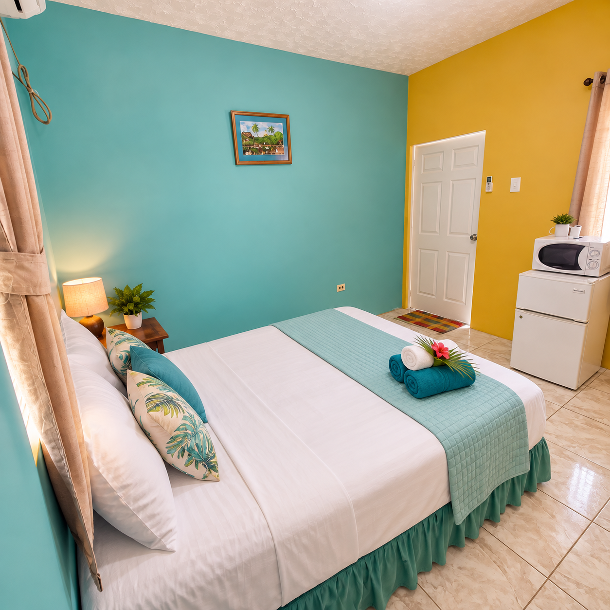 A queen bed against light blue walls, its own bathroom