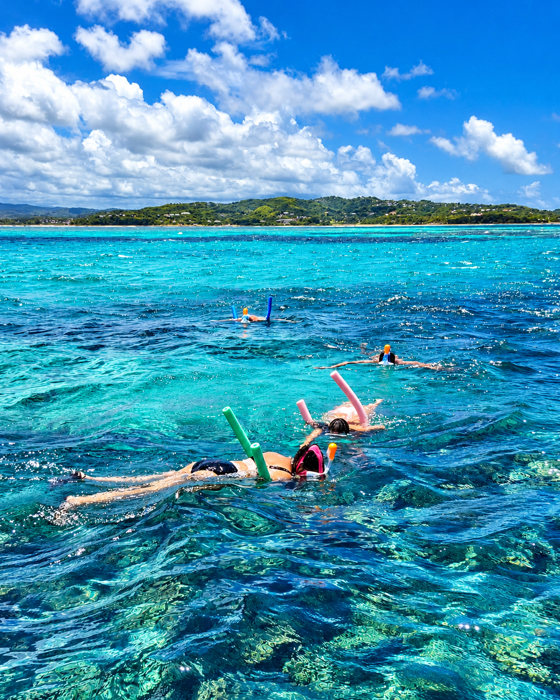 Snorkellers strung out across the shallow flats with floats, the headland in the distance