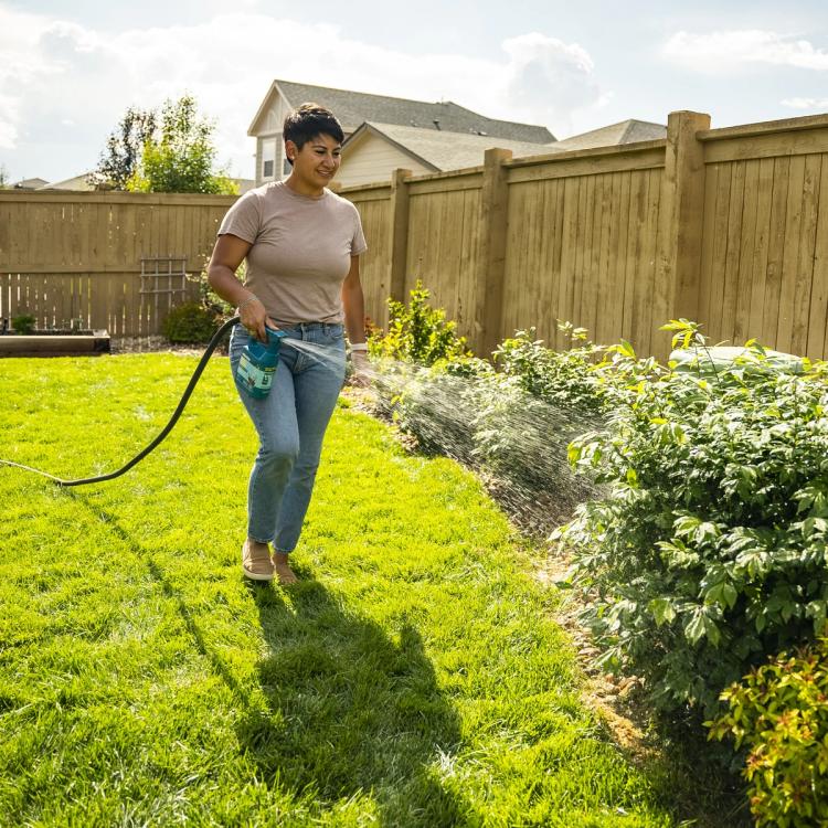 Spraying Nix Ticks in yard via hose