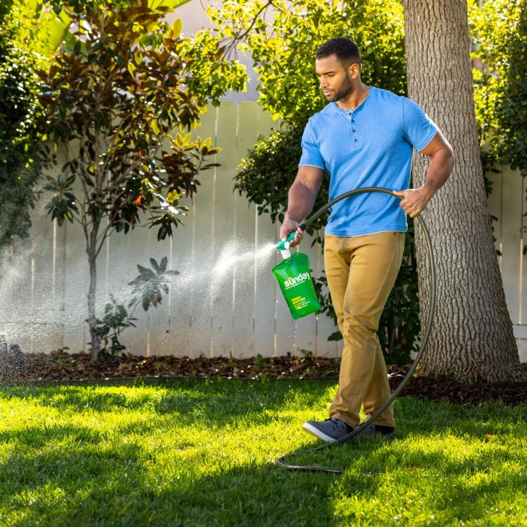 Man spraying Green Machine from his hose
