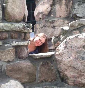 Kara (pictured) leaning out from rock formation in photograph