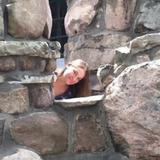 Kara (pictured) leaning out from rock formation in photograph