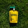 Sunday Lawn Kickstart liquid fertilizer pouch and hose-end sprayer on lawn