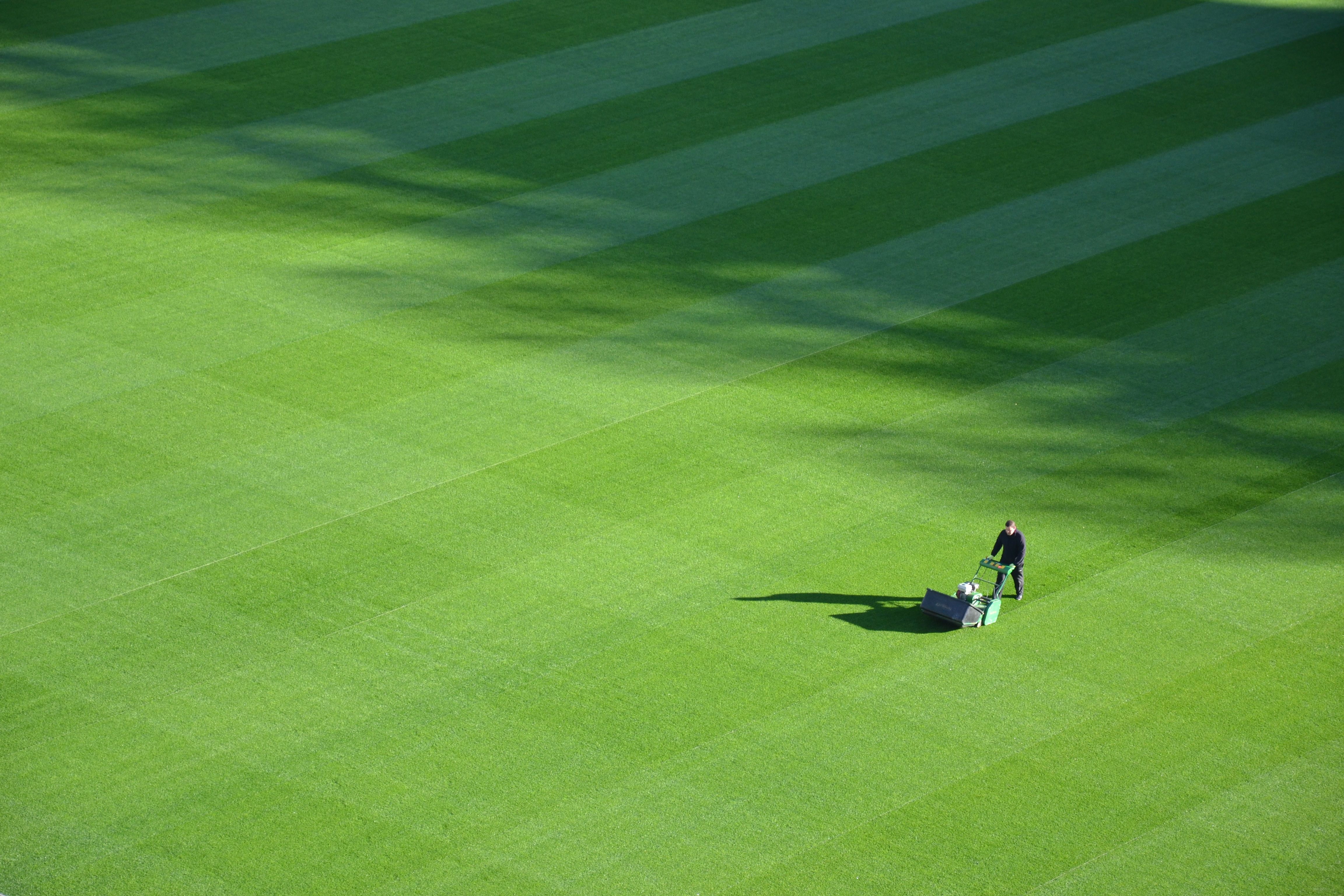 man mowing a large lawn