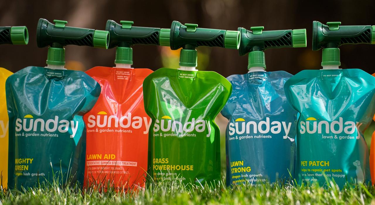 Sunday liquid lawn fertilizer pouches side by side on a lawn