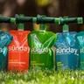 Sunday liquid lawn fertilizer pouches side by side on a lawn
