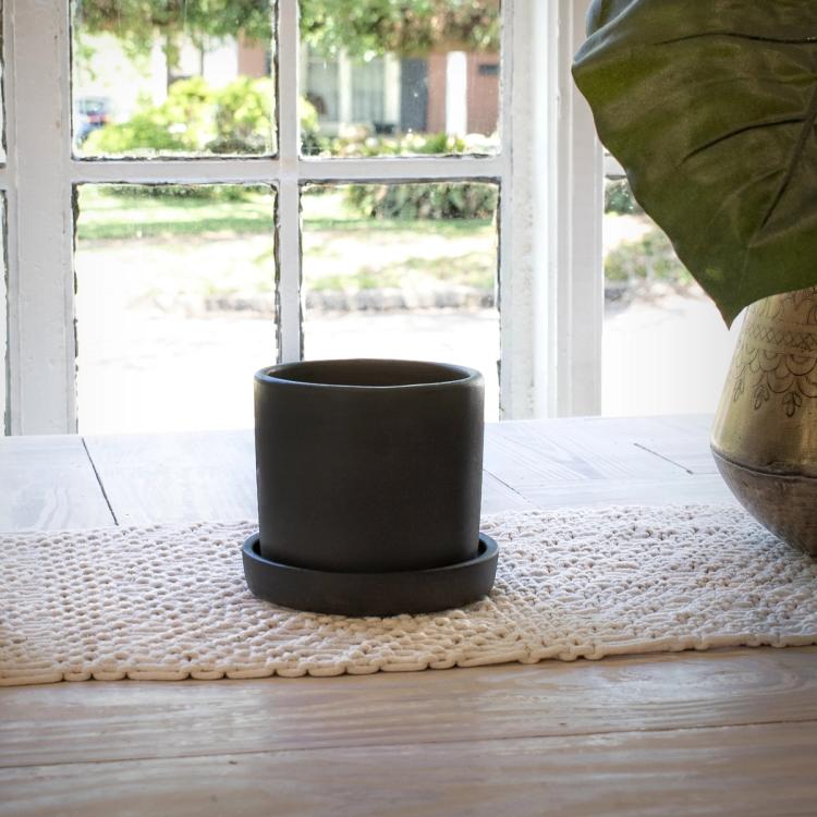 Lifestyle of empty black hyde planter on windowsill