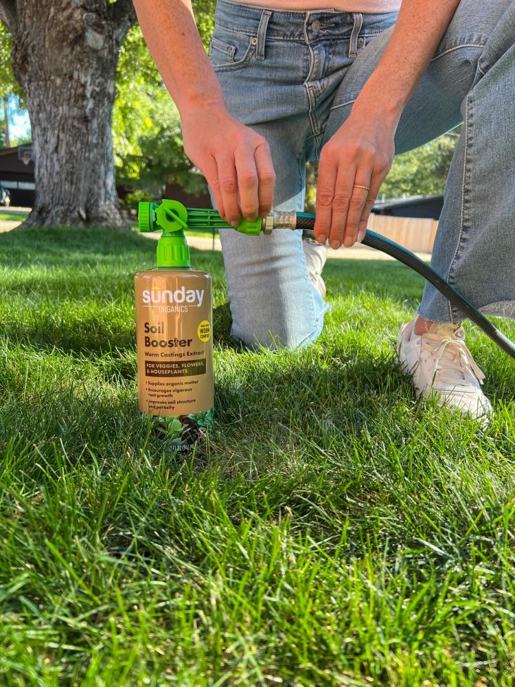Applying hose to hose end sprayer on Soil Booster bottle