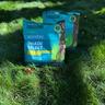 Two bags of Sunday's Shade Select fine fescue grass seed on fescue lawn.