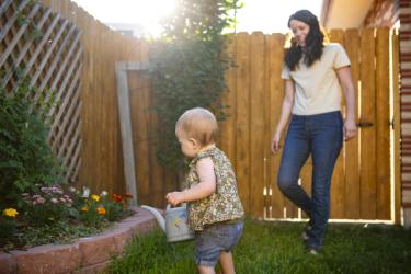 Mother and baby caring for the garden together
