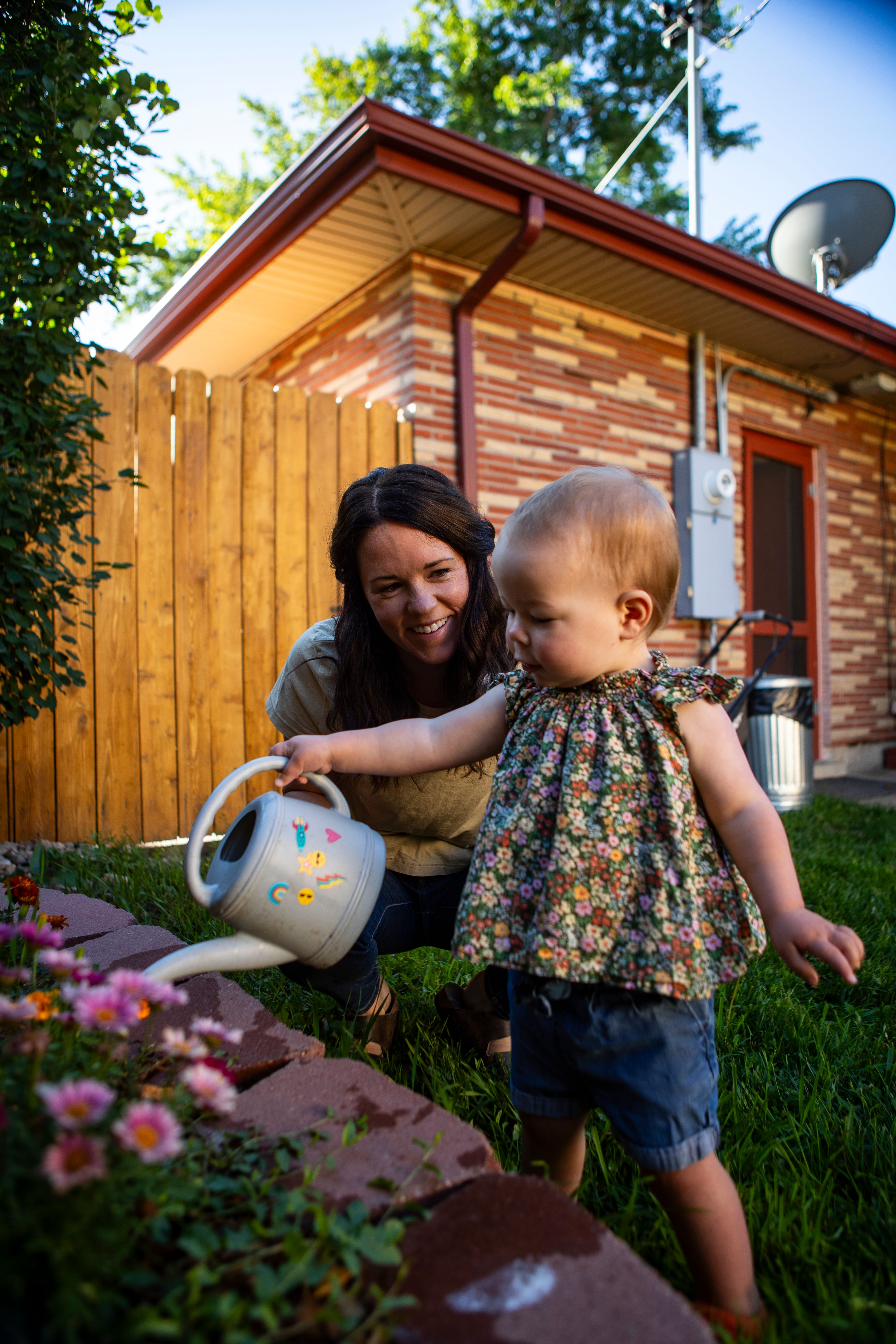 Mom and daughter caring for garden